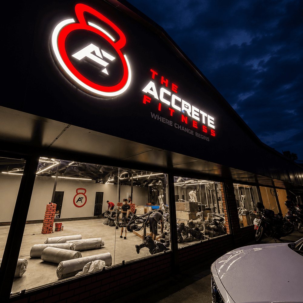 Accrete Fitness storefront and signage at night